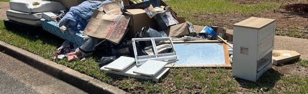 Curbside junk pile ready for same-day haul-away in Mobile